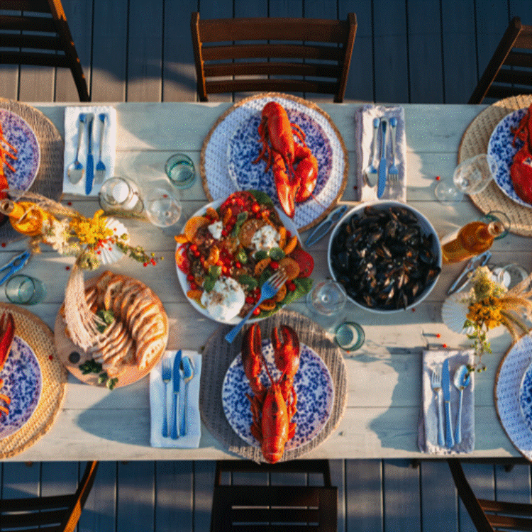 A table with plates of food and glasses

AI-generated content may be incorrect.